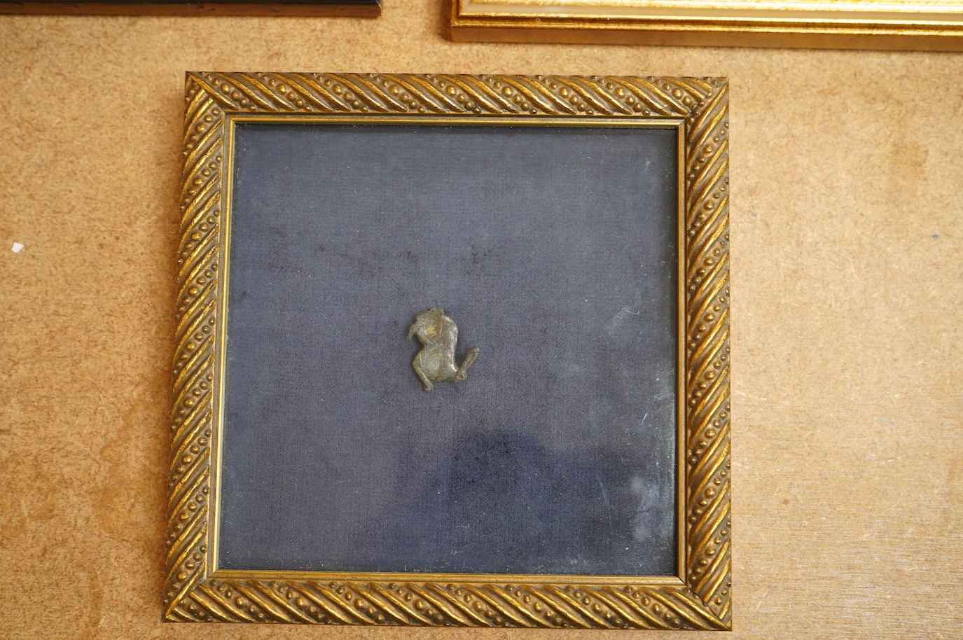 A Roman bronze badge, a medieval pewter badge and silver badges in the form of Sardinia emblems all framed., Swan badge 6cm wide, not including mount or frame. (Requires provenance)